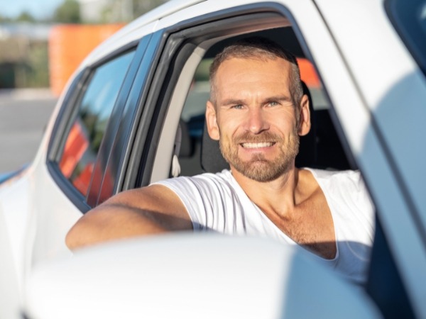 Man Driving a White Car