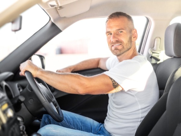 Man Driving a White Car