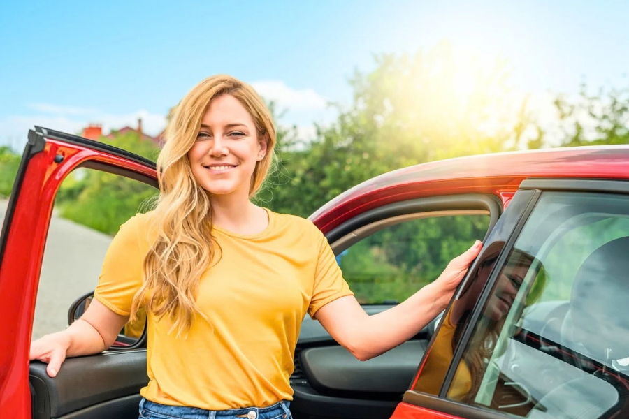 Woman Driving a Red Car