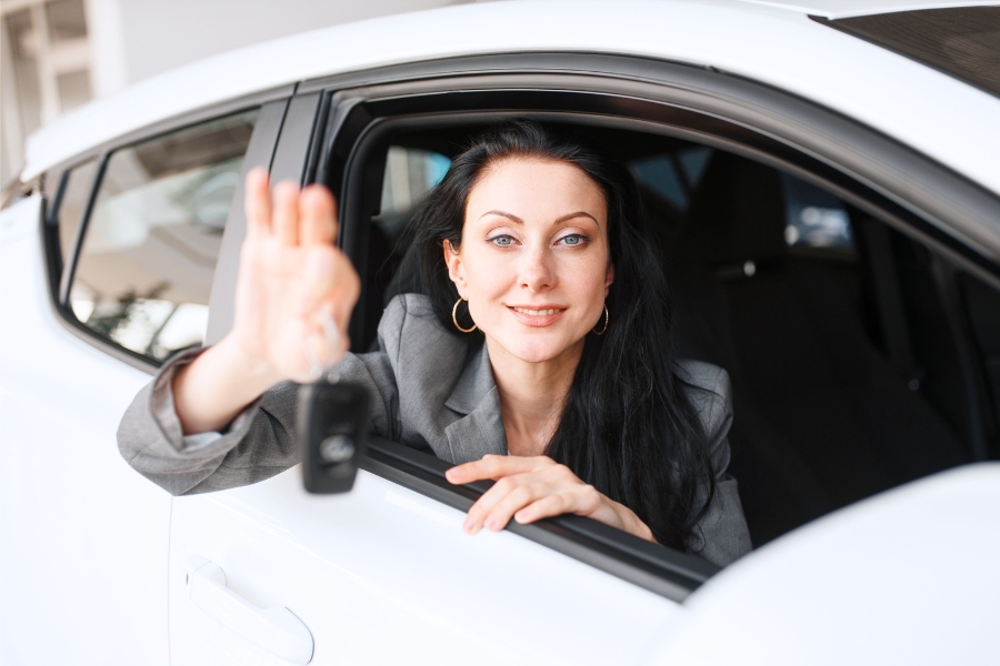 Woman Driving a White Car