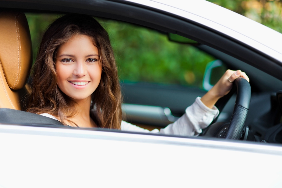 Woman Driving a White Car