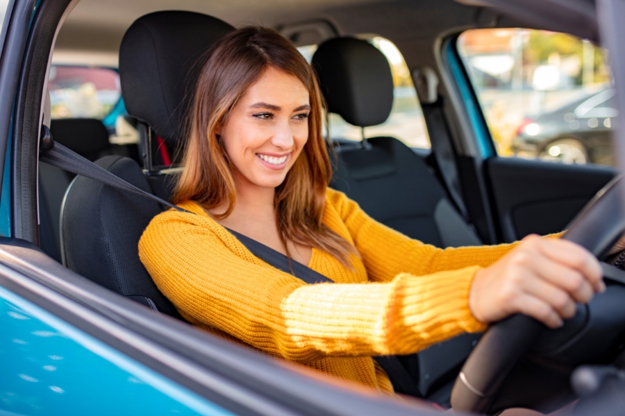 Woman Driving a Blue Car