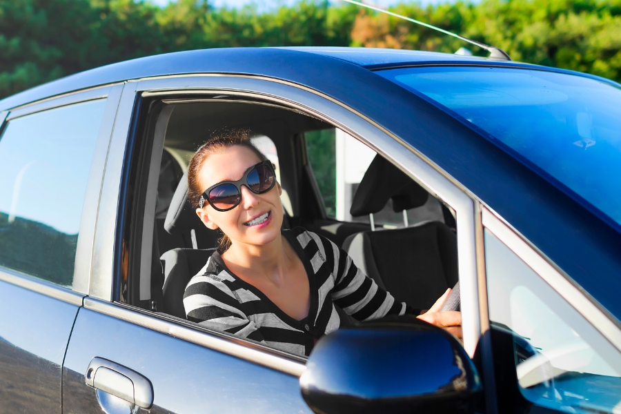 Woman Driving a Car in Nature