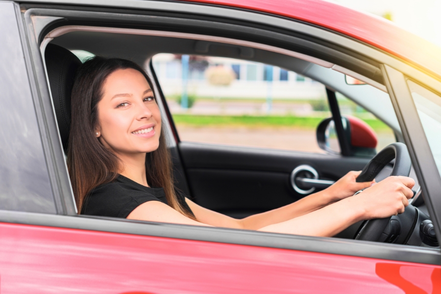 Woman Driving a Red Car