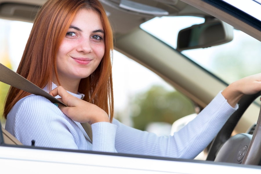 Woman Driving a White Car