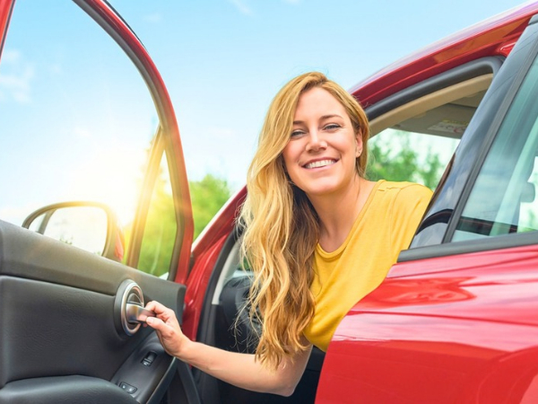 Woman Driving a Red Car