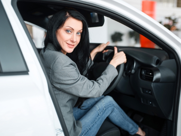 Woman Driving a White Car