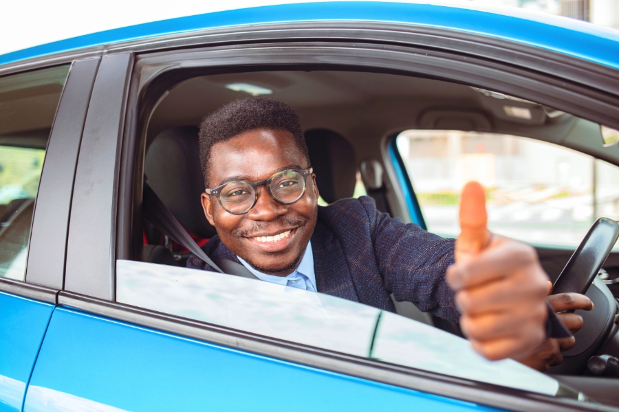 Man Driving a Blue Car