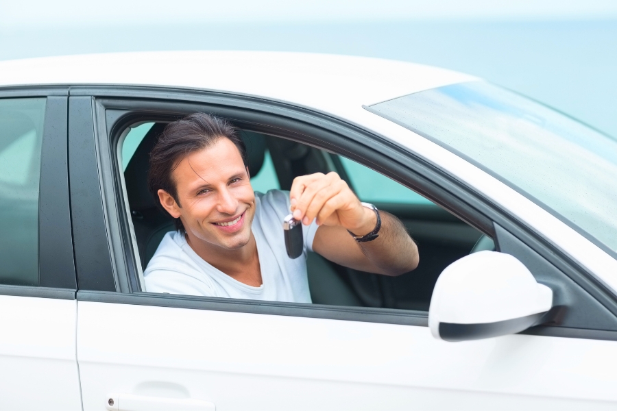 Man Driving a White Car