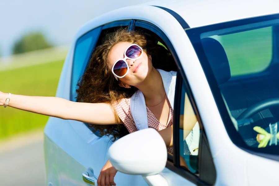 Woman Driving a White Car