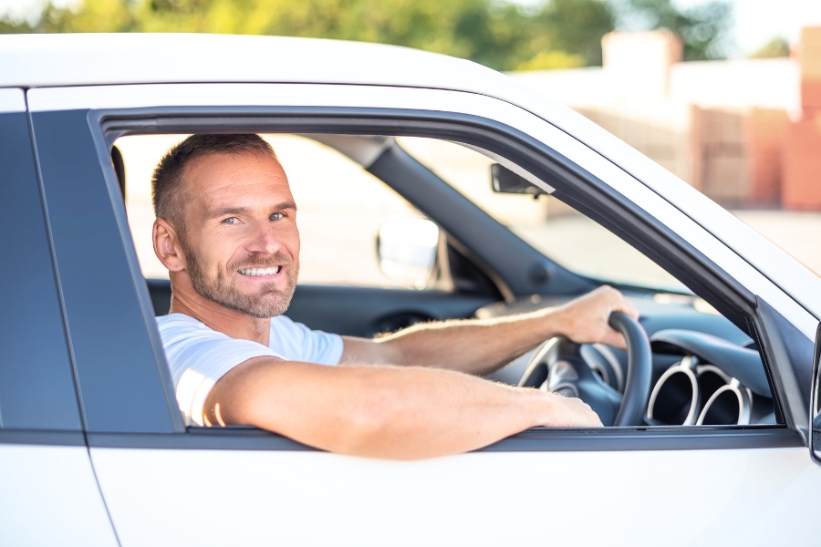 Man Driving a White Car
